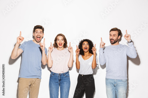 Group of happy multiracial people pointing fingers up