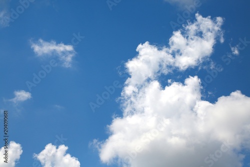 Fluffy Billowy Cumulus Clouds Backlit by the Sun in the Blue Summer Sky in Florida