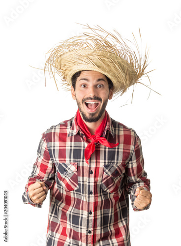 Festa Junina is a brazilian party. Man wearing plaid shirt and straw hat, costume as Caipira. photo