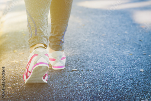 Girl running on the street in the park.