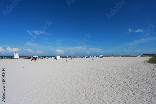 Miami Beach at 8th Street Calle Ocho in a Bright Sunny Afternoon in June with Blue Sky and Scattered Clouds Overhead photo