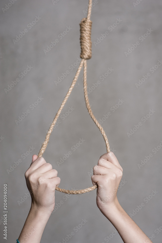women's hands hold a loop. suicide concept women's hands hold a loop. suicide concept