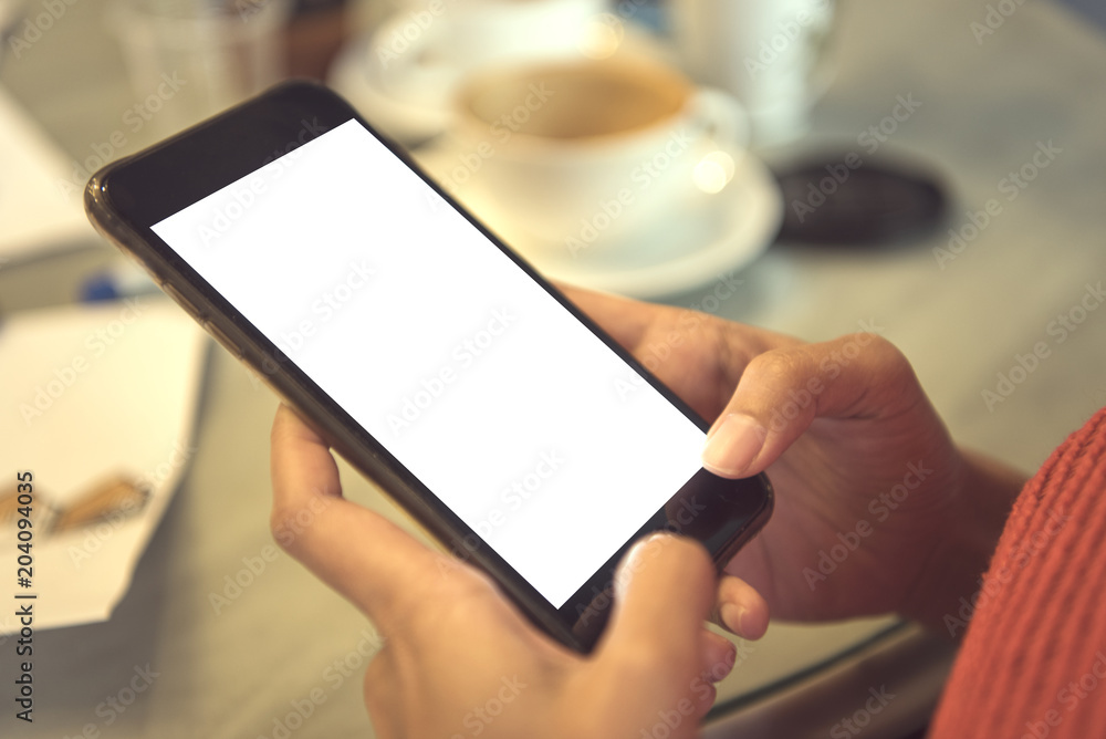 using mobile phone with blank white screen in cafe. mockup advertising. using mobile phone with blank white screen in cafe. mockup advertising.