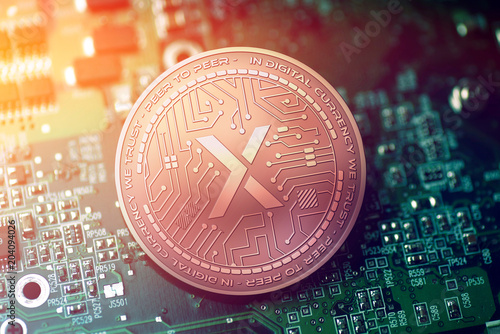 shiny copper STEX cryptocurrency coin on blurry motherboard background