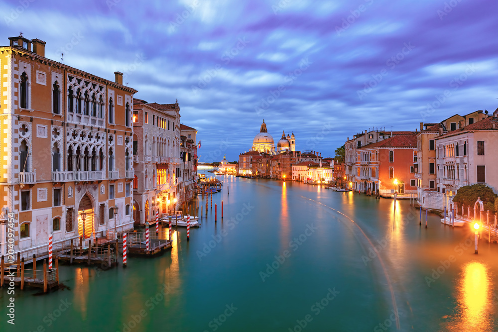 Grand canal and The Basilica of St Mary of Health or Basilica di Santa Maria della Salute at night in Venice, Italy
