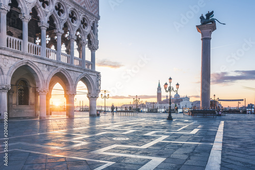 Venice, Veneto, Italy. Sunrise through the arches of Doge's Palace in Piazzetta San Marco.
