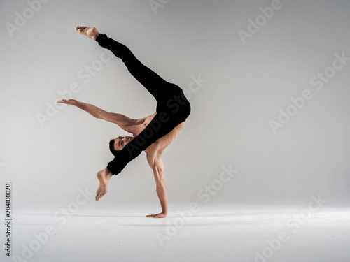 Modern ballet dancer performing art jump with empty copy space background, izolated