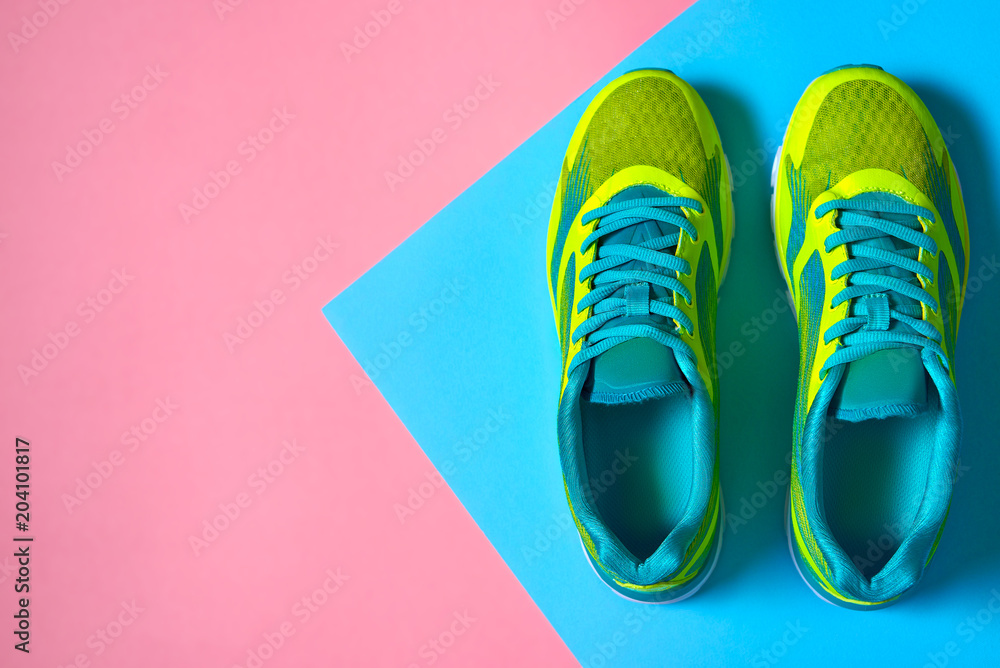 Pair of sport shoes on colorful background. New sneakers on pink and blue  pastel background, copy space. Overhead shot of running shoes. Top view, flat  lay Stock Photo | Adobe Stock
