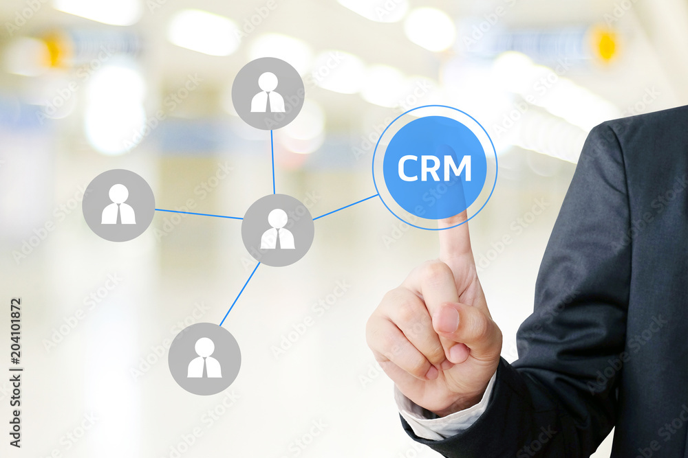 Businessman hand touch CRM, Customer Relationship Management, icon over blur background, success in business concept Businessman hand touch CRM, Customer Relationship Management, icon over blur background, success in business concept