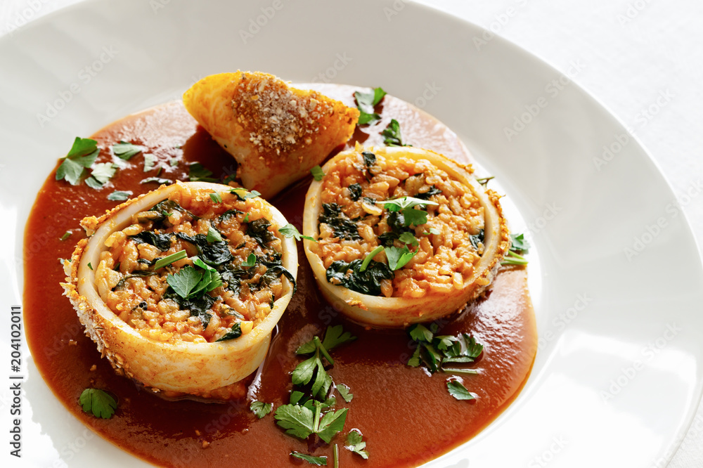 rice and spinach in roasted calamari rings with tomato sauce and parsley rice and spinach in roasted calamari rings with tomato sauce and parsley