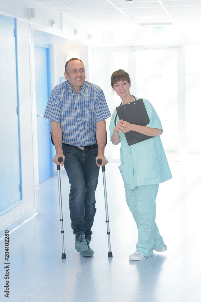 Nurse with patient on crutches Nurse with patient on crutches