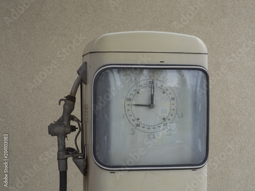 Czech Republic,Prague, April 15, 2018: close up white old retro pumping unit of petrol station from fifties, beige wall background