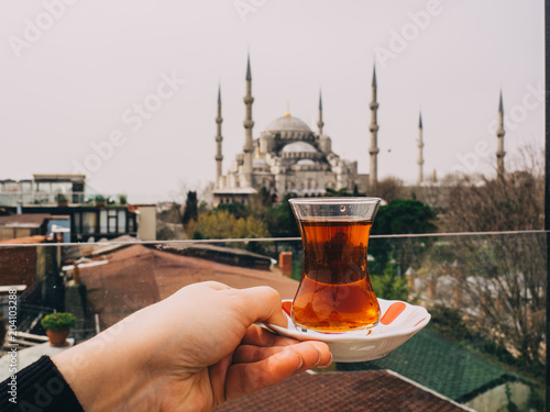 a Cup of Turkish tea on a background of mosques