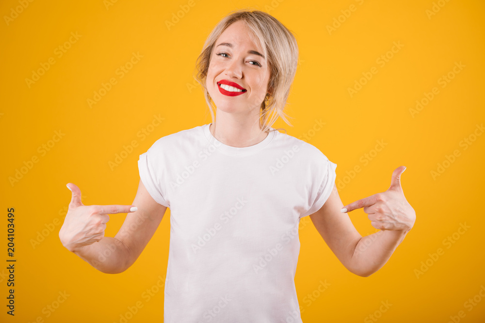 Cool blonde woman in white t-shirt. Yellow background Cool blonde woman in white t-shirt. Yellow background