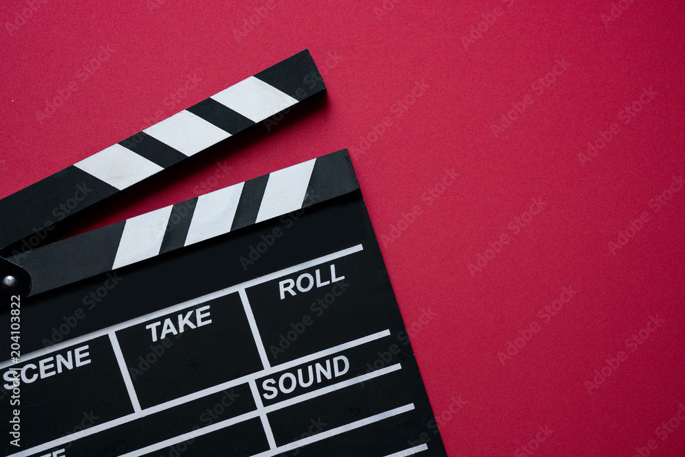 movie clapper on red background ; film, cinema and video photography concept