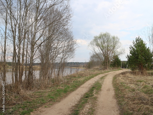country road along the river in the spring