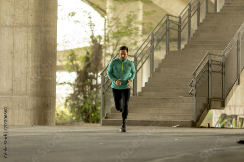 Young man running in urban ...
