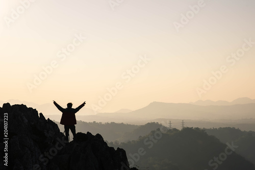 man traveller tourism photographer standing on top of a cliff mountain during sunset - landscape sunset Thailand