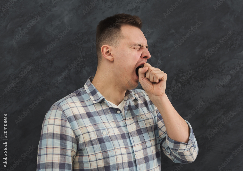 Portrait of young yawning man Portrait of young yawning man
