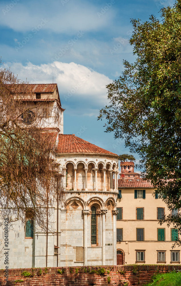 View of Lucca medieval historic center with Cathedral apse and the charcteristic Guinigi Tower from ancient city walls