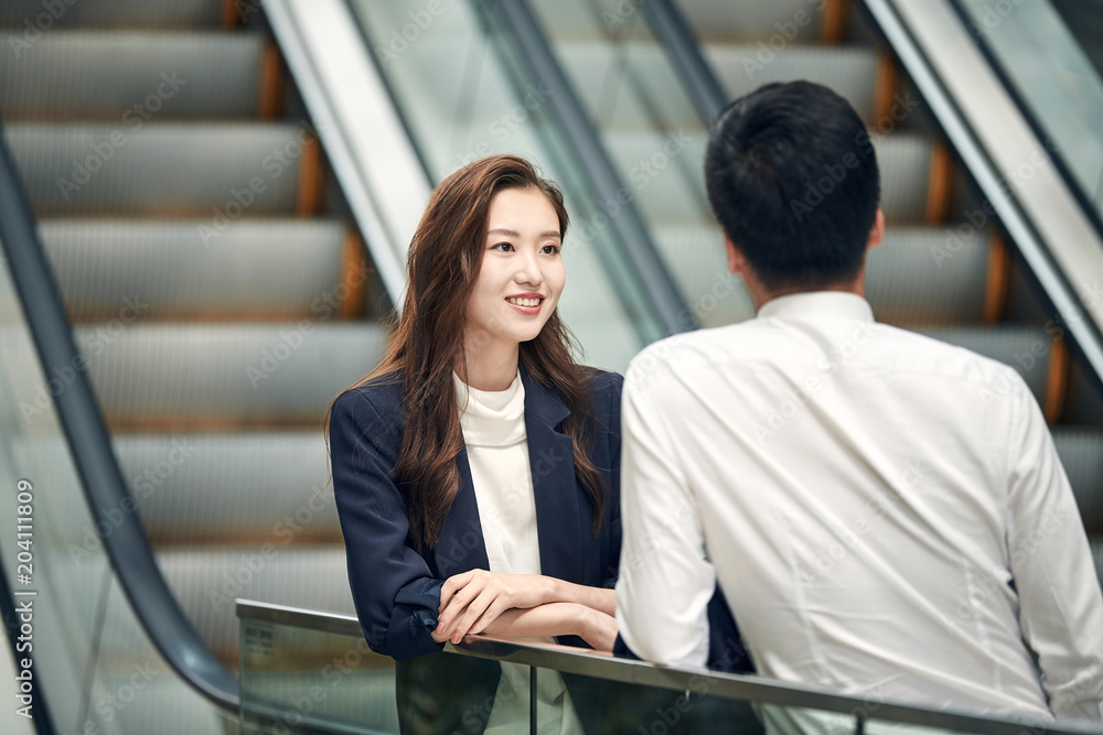 Business people talking in the elevator Business people talking in the elevator