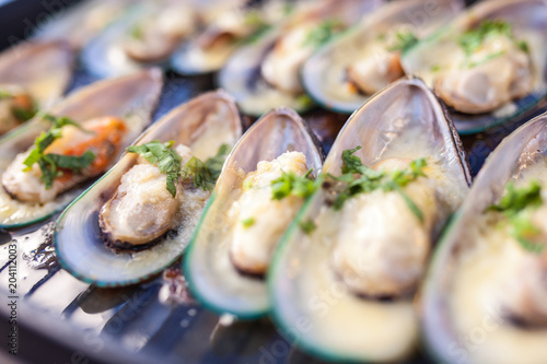 Delicious seafood mussels with with sauce and parsley, Clams in the shells photo