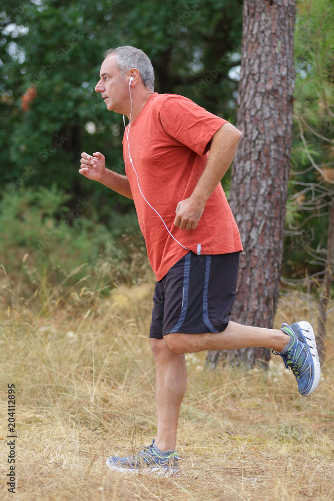 Obraz premium middle aged man in sports uniform warming up