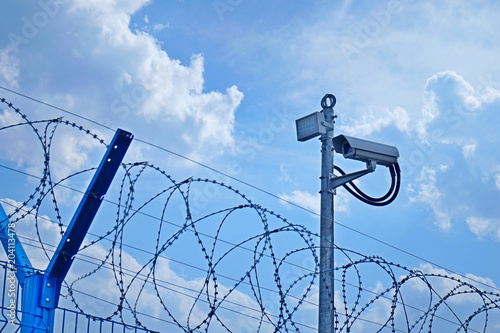 Fence, barbed wire and video camera.