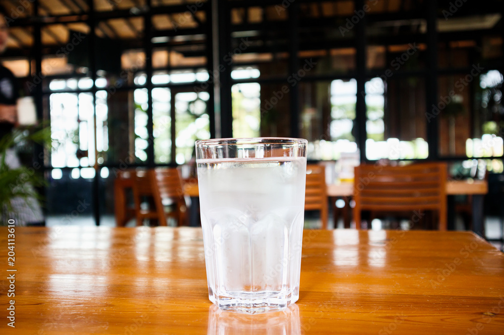 glass of mineral water on wood table in restaurant glass of mineral water on wood table in restaurant