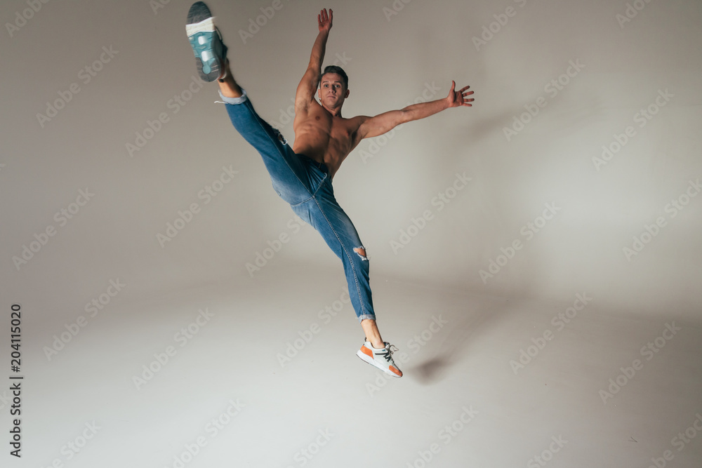 Naklejka premium shot of mad, crazy, cheerful, successful, lucky guy in casual outfit, jeans, jumping with hands up,triumphant, gesturing against white background