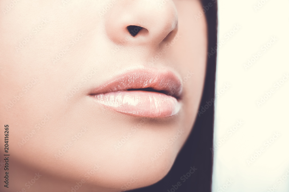 Fototapeta premium Sexy Lips. Beauty Lipgloss Makeup Detail. Beautiful Make-up Close up