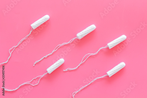 Woman hygiene protection. Cotton tampons like sperms on pink background top view pattern