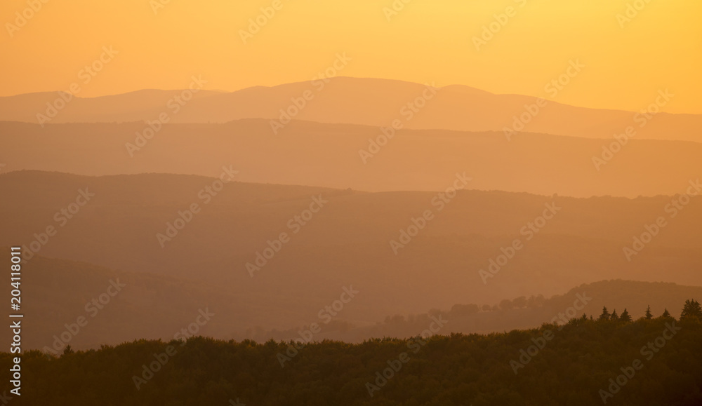 Hills during orange sundown. Natural composition