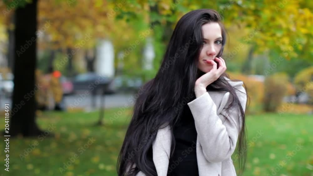 portrait of a beautiful brunette woman in an autumn park portrait of a beautiful brunette woman in an autumn park