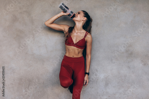 Female athlete drinking water