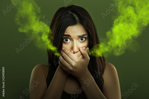Halitosis concept of woman with bad breath photo
