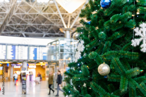Christmas tree in the airport and Flight schedule information board