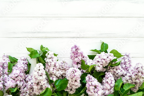 Spring lilac flowers on white wooden background. Flat lay  top view  copy space