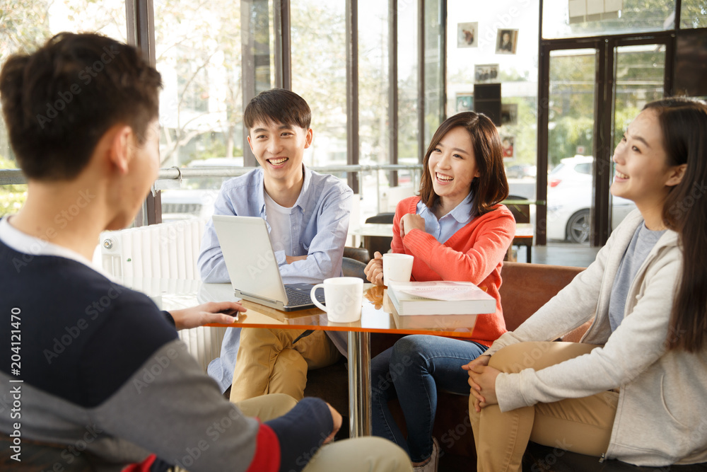 Young men and women in the coffee shop Young men and women in the coffee shop
