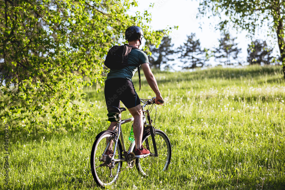 Young man drive his bike in nature