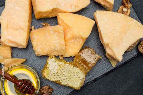 pieces of parmesan or parmigiano cheese and honey photo