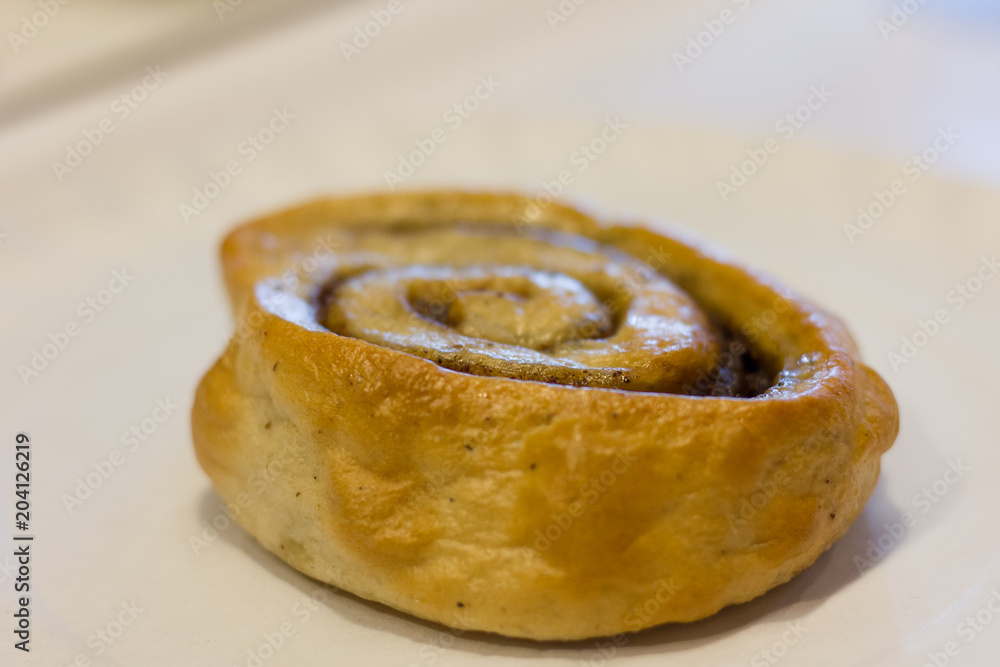 Delicious cinnamon roll on white plate. Dessert concept Delicious cinnamon roll on white plate. Dessert concept