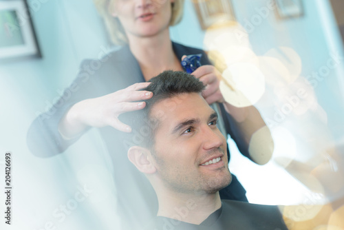 man at the hairdresser salon hairstyle make model