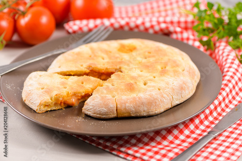 Pizza calzone on wooden background