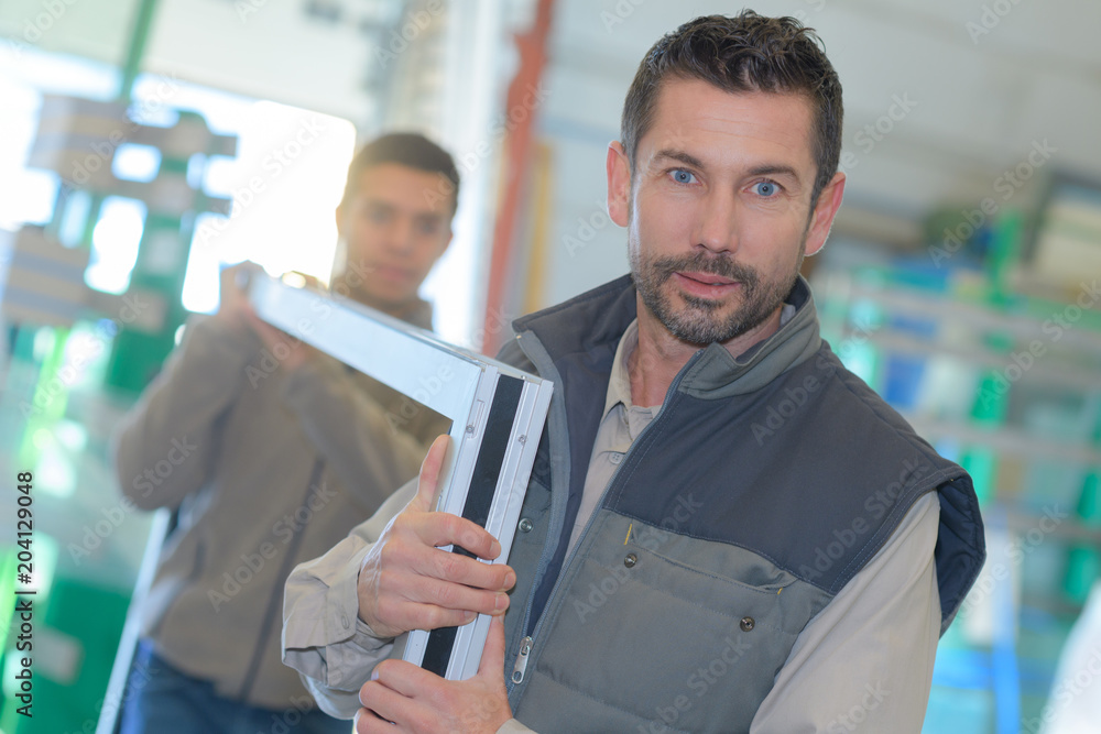 men carrying windows frames men carrying windows frames