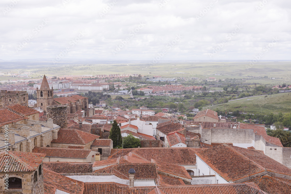 Aerial views of the beautiful city of Caceres, Spain. Stone fortress town. Cathedral in front. Cloudy sky