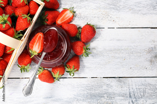 Strawberry jam in a jar and fresah strawberries. photo