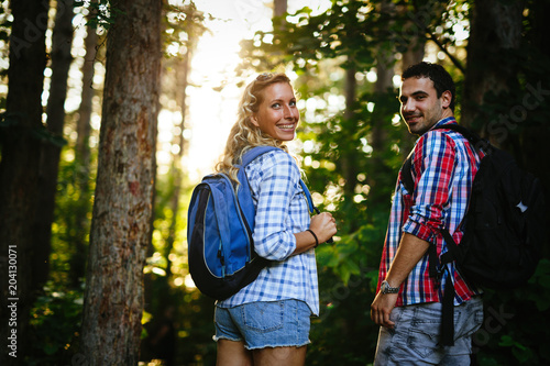 Couple trekking and hiking in forest © NDABCREATIVITY