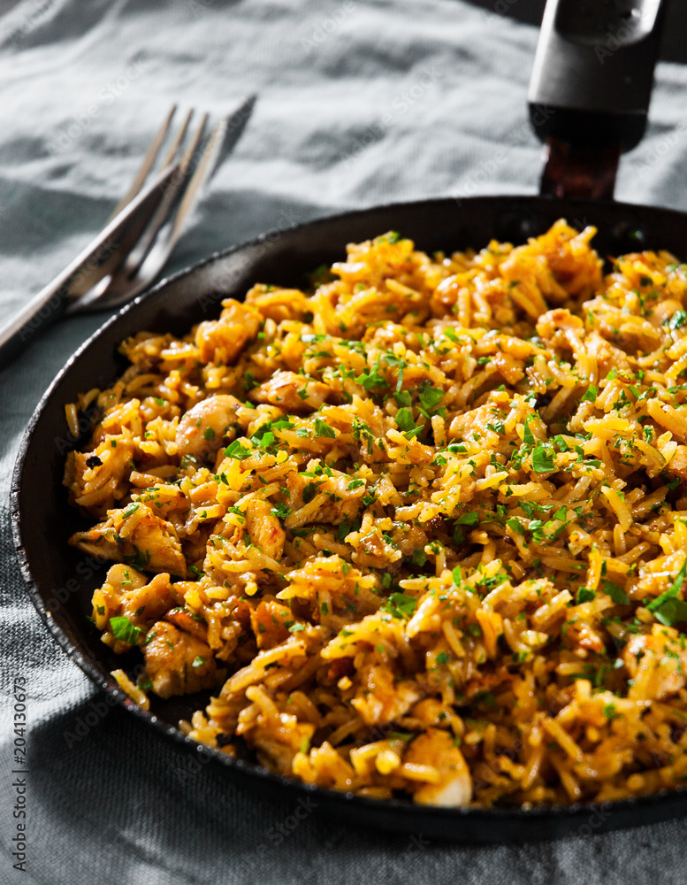 Chicken Breast with Rice and vegetables in a frying pan on dark wooden background Chicken Breast with Rice and vegetables in a frying pan on dark wooden background