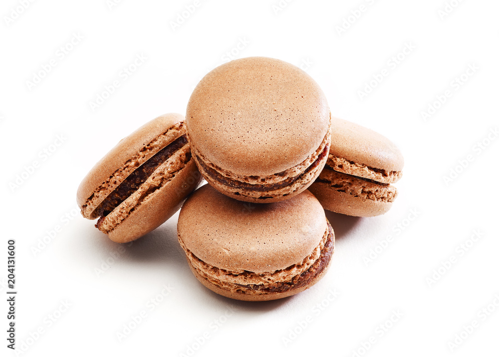 Fresh baked brown Macarons, or macaroons isolated on white background Fresh baked brown Macarons, or macaroons isolated on white background